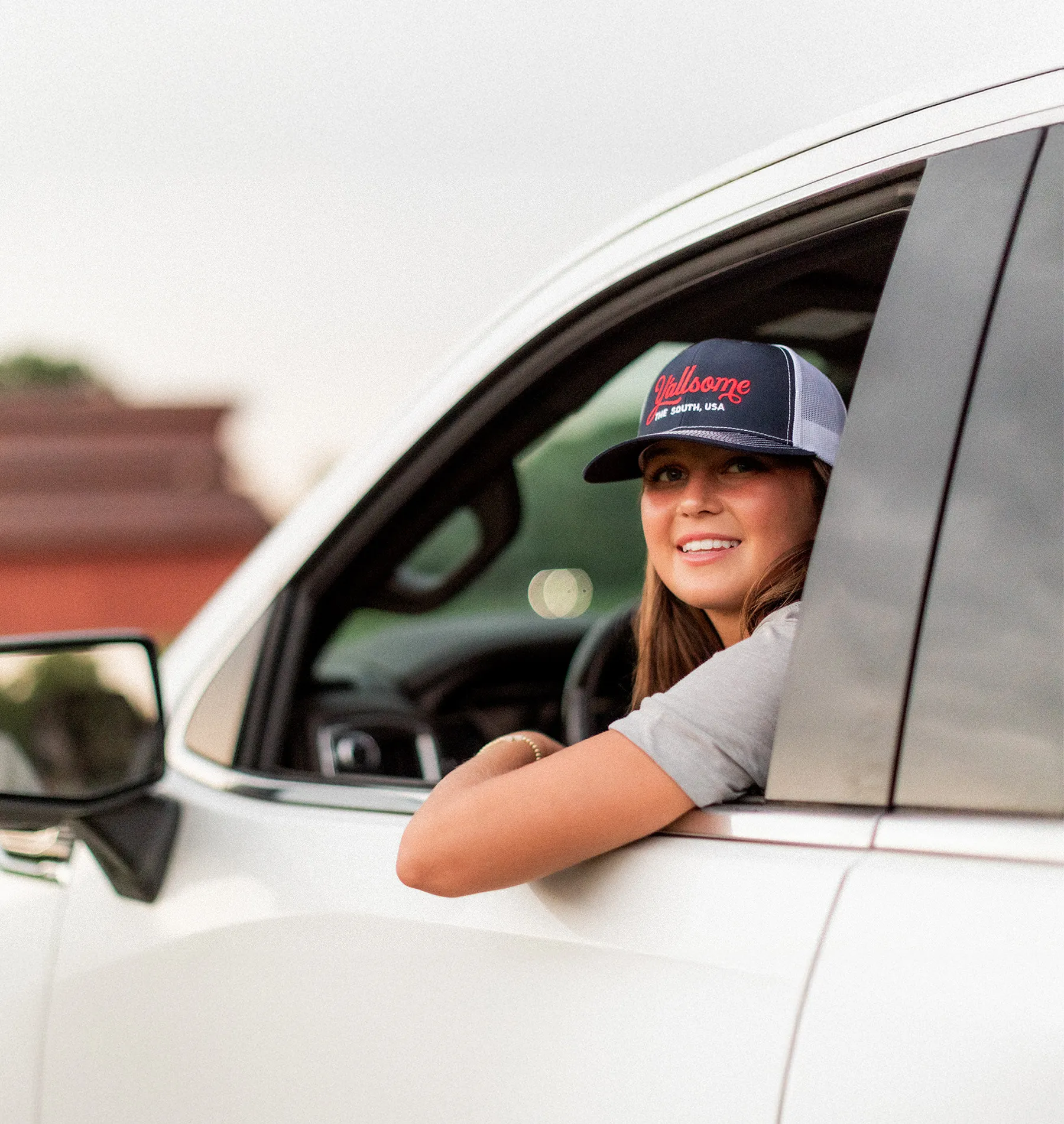 Y'allsome hat — smiling from a truck window